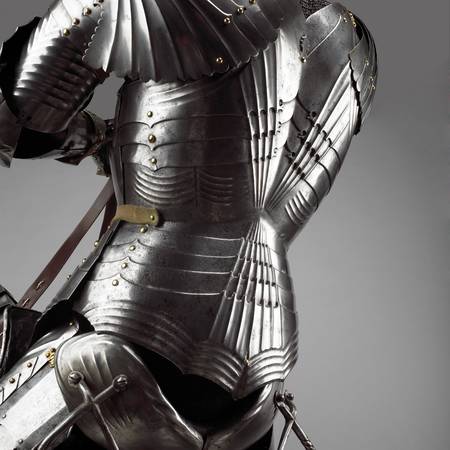 Close up detail of the back of a medieval knight on an armoured horse