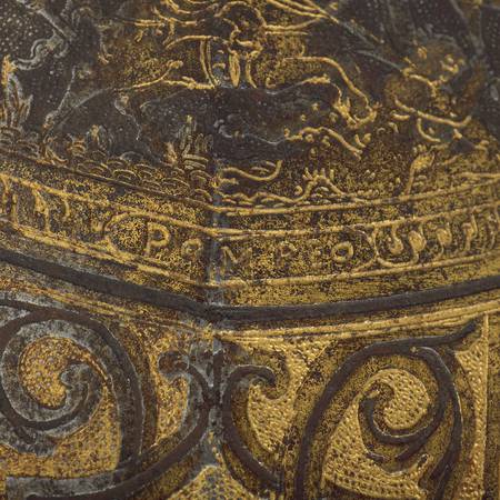 Close up detail of the gold etching on a piece of armour
