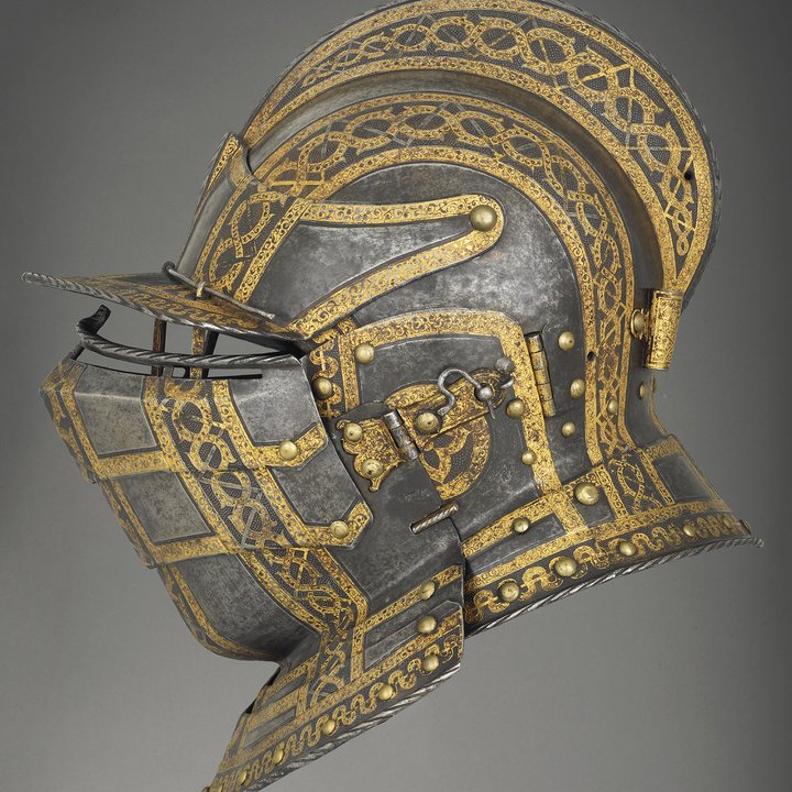 A side view of a sixteenth-century helmet with visor and gold detailing