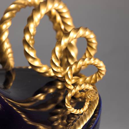 A detail of a porcelain vase mounted in gilt bronze