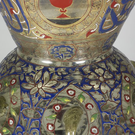 Detail of glass lamp with blue and gold illustrations of flowers and fish
