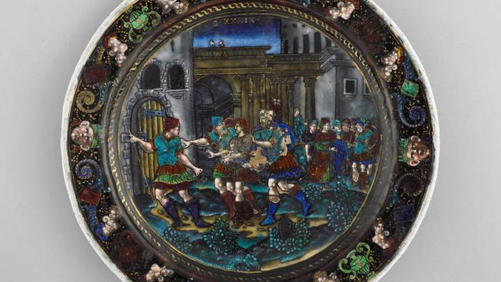 An image of an enamel plate decorated with a scene of Joseph being taken to prison