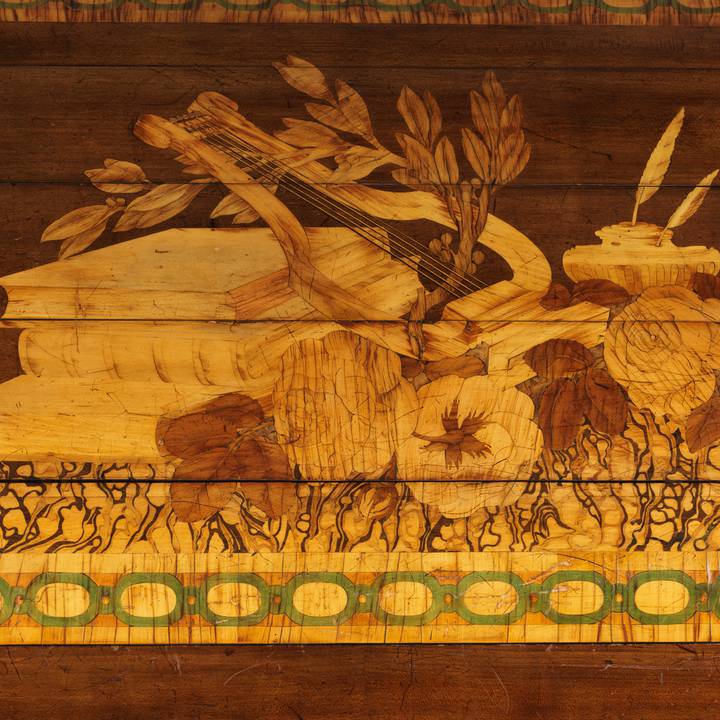 A detail of pictorial marquetry on the tambour of a roll-top desk