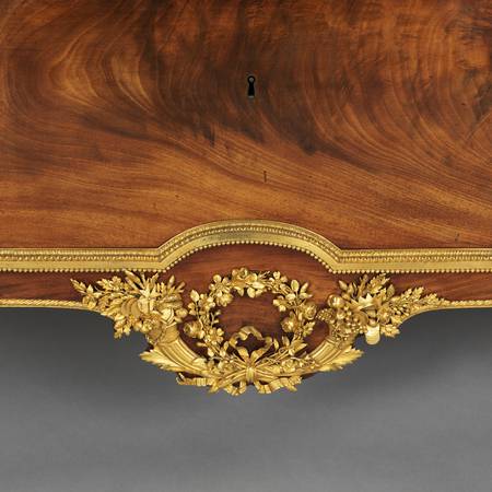 A detail of gilt-bronze mounts on a chest-of-drawers