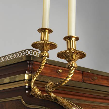 A detail of candelabra on the corner of an eighteenth-century cylinder desk