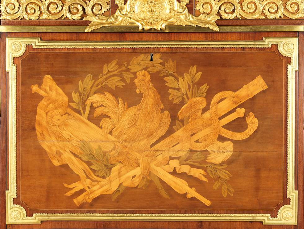 A detail of the pictorial marquetry on the fall-front of a fall-front desk