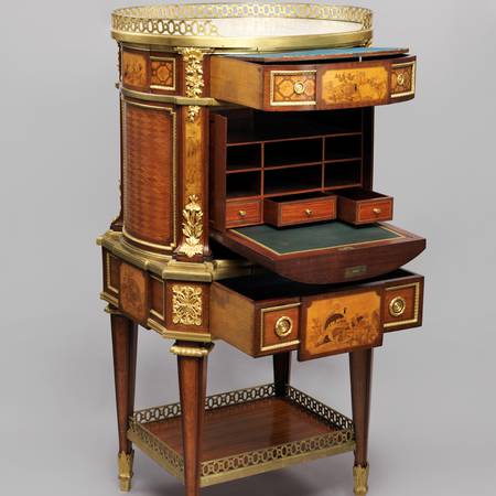 A photograph of a nineteenth-century writing-desk with its drawers open