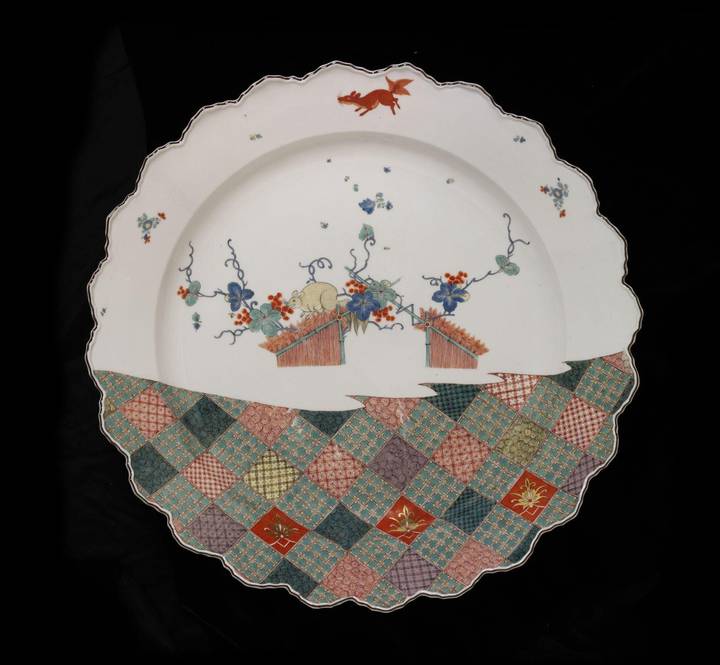 Fig. 8: This Meissen dish combines the delicate flowers on a white ground typical of Japanese Kakiemon porcelain with the busy geometric pattern of Imari porcelain, c. 1735. © Victoria & Albert Museum, London (C.75-1957)