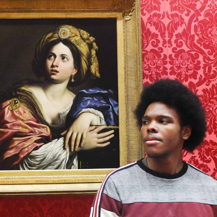 Young man in front of painting