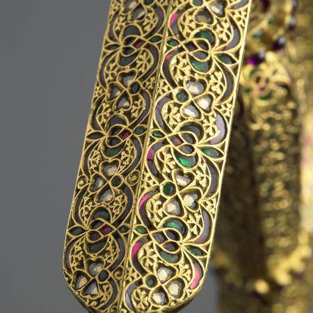 Ornate detail of gold jewelled dagger handle