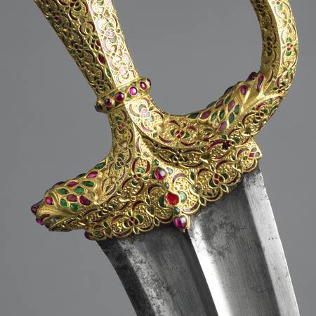 Detail of gold jewelled dagger handle with lion head