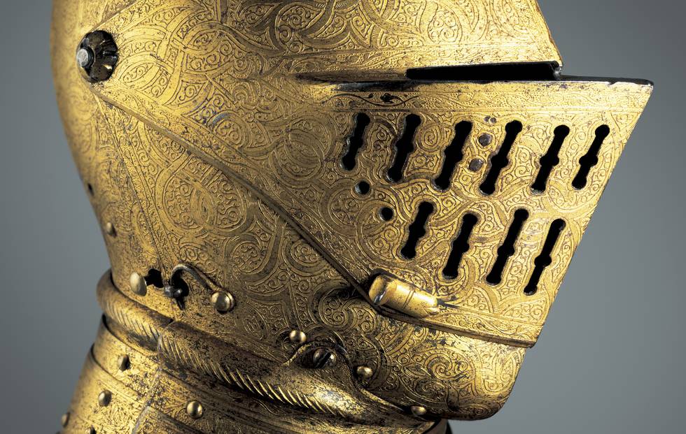 Close up photograph of the side of a gold helmet