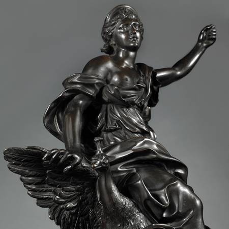 A detail of a seventeenth-century sculpture, showing a female figure with her arm raised