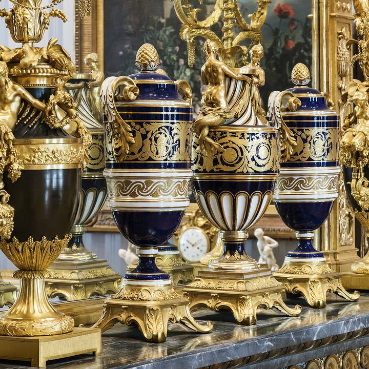 Ornate blue and gold urns on a shelf
